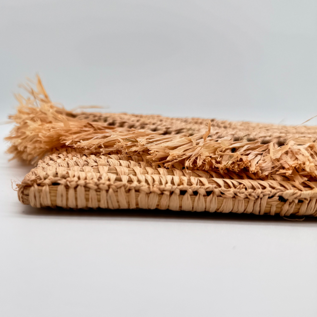 Halbmondförmige Bastclutch aus natürlichem Raffia mit langen, unregelmäßigen Fransen am oberen Rand