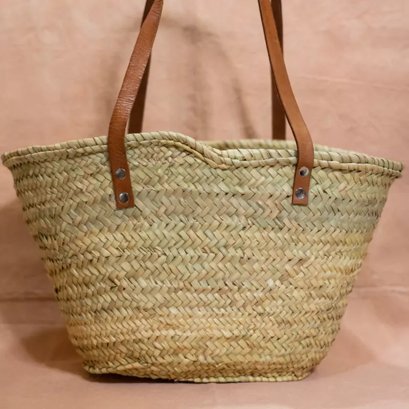 Handgewebte Strohtasche aus Naturstroh mit zwei schmalen, braunen Lederhenkeln