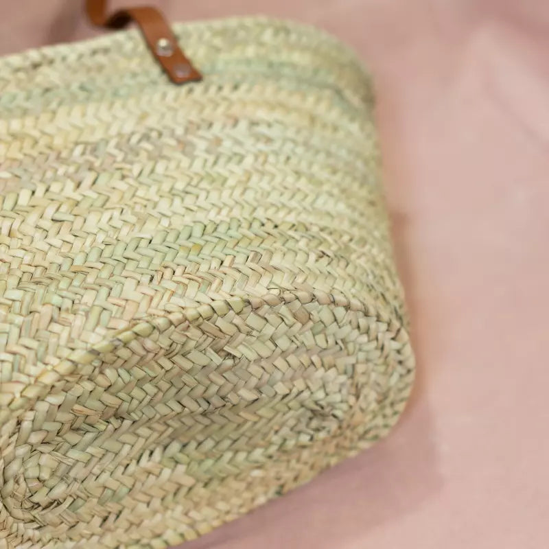 Handgewebte Strohtasche aus Naturstroh mit zwei schmalen, braunen Lederhenkeln